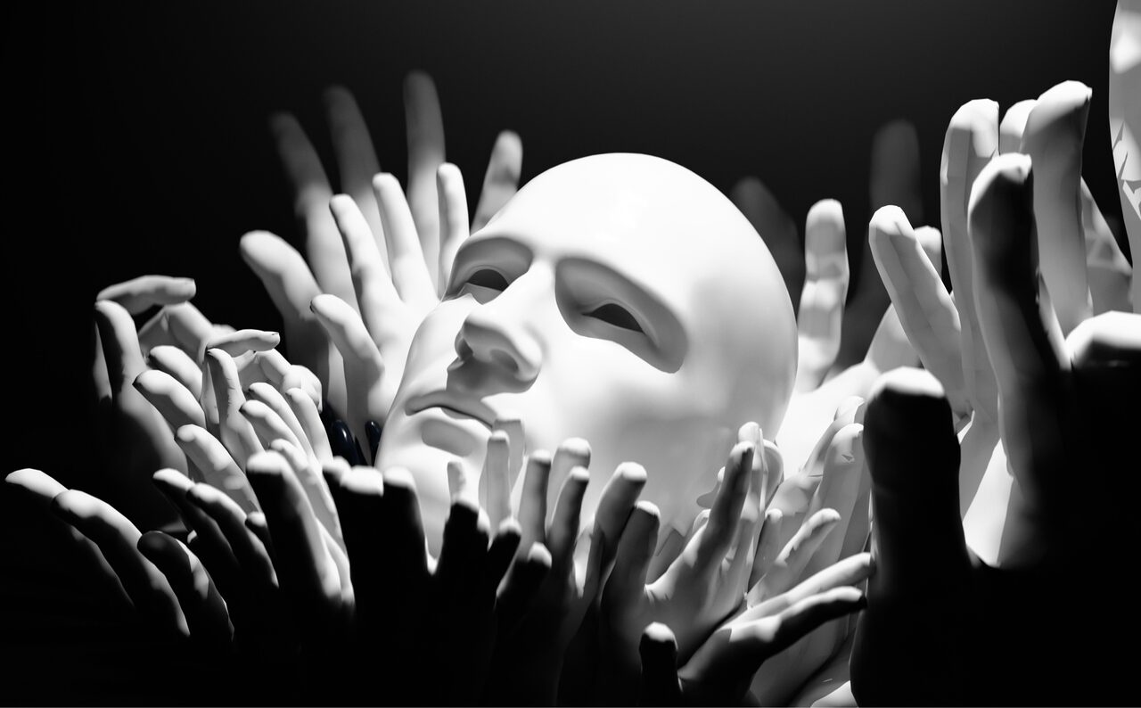 A luminous humanlike face surrounded by many reaching hands in black and white.